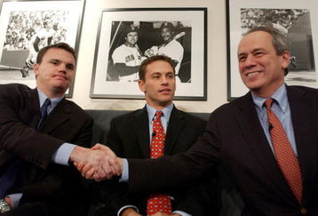 BOSTON - DECEMBER 12: Red Sox CEO/President Larry Lucchino (R) introduces Co-General Managers Ben Cherington (L) and Jed Hoyer December 12, 2005 at a press conference at Fenway Park in Boston, Massachusetts. Both Cherington and Hoyer have been with the Red Sox in other capacities for a number of years, and helped in the latest transitions following the resignation of former GM Theo  Epstein.  (Photo  by Darren McCollester/Getty Images)