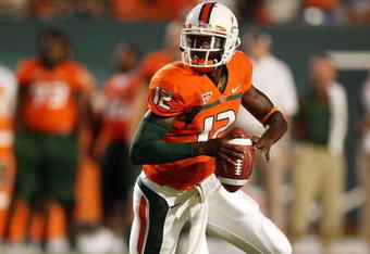 MIAMI GARDENS, FL - SEPTEMBER 17:  Quarterback Jacory Harris #12 of the Miami Hurricanes scrambles against the Georgia Tech Yellow Jackets at Land Shark Stadium on September 17, 2009 in Miami Gardens, Florida. Miami defeated Georgia Tech 33-17.  (Photo by Doug Benc/Getty Images)