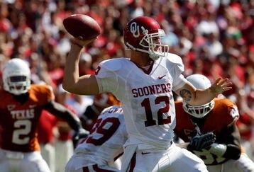 DALLAS - OCTOBER 17:  Quarterback Landry Jones #12 of the Oklahoma Sooners drops back to pass against the Texas Longhorns at Cotton Bowl on October 17, 2009 in Dallas, Texas.  (Photo by Ronald Martinez/Getty Images)