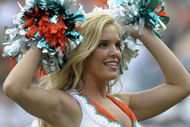 MIAMI, FL - JANUARY 4: A cheerleader of the Miami Dolphins entertains during play against the Baltimore Ravens in an NFL Wildcard Playoff Game at Dolphins Stadium on January 4, 2009 in Miami, Florida. (Photo by Al Messerschmidt/Getty Images)