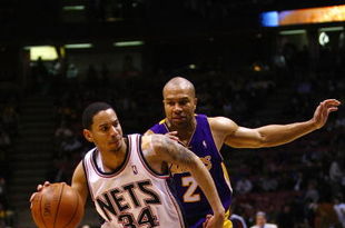 EAST RUTHERFORD, NJ - MARCH 27:  Devin Harris #34 of the New Jersey Nets drives against Derek Fisher #2 of the Los Angeles Lakers during the game on March 27, 2009 at the Izod Center in East Rutherford, New Jersey. NOTE TO USER: User expressly acknowledges and agrees that, by downloading and/or using this Photograph, User is consenting to the terms and conditions of the Getty Images License Agreement.  (Photo by Chris McGrath/Getty Images)