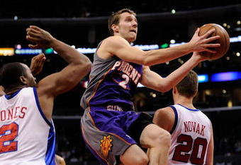 LOS ANGELES, CA - FEBRUARY 18:  Goran Dragic #2 of the Phoenix Suns drives to the basket in between scores against Fred Jones #2  and Steve Novak #20 of the Los Angeles Clippers at the Staples Center on February 18, 2009 in Los Angeles, California.  NOTE TO USER: User expressly acknowledges and agrees that, by downloading and or using this photograph, User is consenting to the terms and conditions of the Getty Images License Agreement.  (Photo by Kevork Djansezian/Getty Images)