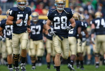 SOUTH BEND, IN - OCTOBER 03: Kyle McCarthy #28 and Anthony McDonald #54 of the Notre Dame Fighting Irish run onto the field with teammates before a game against the Washington Huskies on October 3, 2009 at Notre Dame Stadium in South Bend, Indiana. Notre Dame defeated Washington 37-30 in overtime.  (Photo by Jonathan Daniel/Getty Images)