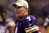 MINNEAPOLIS - OCTOBER 05:  Quarterback Brett Favre #4 of the Minnesota Vikings watches the reply from the sidelines after a touchdown during the game against the Green Bay Packers on October 5, 2009 at Hubert H. Humphrey Metrodome in Minneapolis, Minnesota.  (Photo by Jamie Squire/Getty Images)