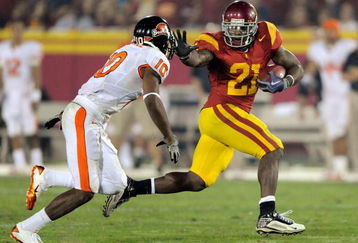 LOS ANGELES, CA - OCTOBER 24:  Allen Bradford #21 of the USC Trojans runs away from his defender Lance Mitchell #10 of the Oregon State Beavers for a large gain during the third quarter of the college football game at Los Angeles Memorial Coliseum on October 24, 2009 in Los Angeles, California.  (Photo by Kevork Djansezian/Getty Images)