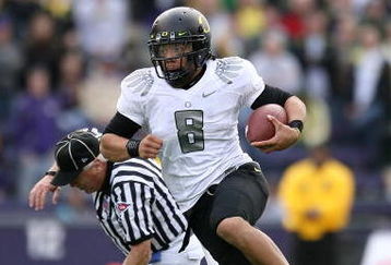 SEATTLE - OCTOBER 24:  Quarterback Jeremiah Masoli #8 of the Oregon Ducks rushes against Joshua Gage #24 of the Washington Huskies on October 24, 2009 at Husky Stadium in Seattle, Washington. The Ducks defeated the Huskies 43-19. (Photo by Otto Greule Jr/Getty Images)