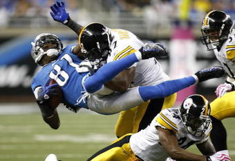 DETROIT , MI - OCTOBER 11: Calvin Johnson #81 of the Detroit Lions is tackled by James Harrison #92 of the Pittsburgh Steelers October 11, 2009 at Ford Field in Detroit, Michigan. Johnson was injured on the play. (Photo by Gregory Shamus/Getty Images)