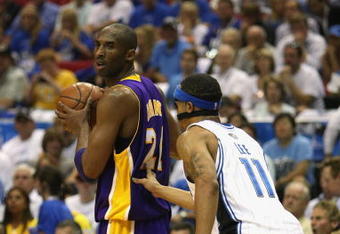 ORLANDO, FL - JUNE 14:  Kobe Bryant #24 of the Los Angeles Lakers looks to move the ball against Courtney Lee #11 of the Orlando Magic in Game Five of the 2009 NBA Finals on June 14, 2009 at Amway Arena in Orlando, Florida. The Lakers won 99-86. NOTE TO USER:  User expressly acknowledges and agrees that, by downloading and or using this photograph, User is consenting to the terms and conditions of the Getty Images License Agreement. (Photo by Elsa/Getty Images) 