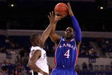 INDIANAPOLIS - MARCH 27:  Sherron Collins #4 of the Kansas Jayhawks attempts a shot against Travis Walton the Michigan State Spartans during the third round of the NCAA Division I Men's Basketball Tournament at the Lucas Oil Stadium on March 27, 2009 in Indianapolis, Indiana.  (Photo by Andy Lyons/Getty Images)