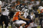 MIAMI - OCTOBER 14:  Chris Smith #26 and Marshall McDuffie Jr. #24 of the Florida International Panthers fight Ross Abramson #86 of the Miami Hurricanes during an on field fight at the Orange Bowl on October 14, 2006 in Miami, Florida. Miami won 35-0.  (Photo by Marc Serota/Getty Images)
