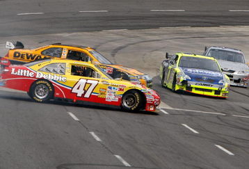 MARTINSVILLE, VA - OCTOBER 25:  Marcos Ambrose, driver of the #47 Little Debbie/Kingsford/Clorox Toyota, Matt Kenseth, driver of the #17 DeWalt Ford, and Robby Gordon, driver of the #7 Schrock/Menards Toyota, get together in Turn 4 during the NASCAR Sprint Cup Series TUMS Fast Relief 500 at Martinsville Speedway on October 25, 2009 in Martinsville, Virginia.  (Photo by Streeter Lecka/Getty Images)