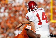 DALLAS - OCTOBER 17: Quarterback Sam Bradford #14 of the Oklahoma Sooners is tackled by Lamarr Houston #33 of the Texas Longhorns at Cotton Bowl on October 17, 2009 in Dallas, Texas. (Photo by Ronald Martinez/Getty Images)