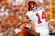 DALLAS - OCTOBER 17:  Quarterback Sam Bradford #14 of the Oklahoma Sooners is tackled by Lamarr Houston #33 of the Texas Longhorns at Cotton Bowl on October 17, 2009 in Dallas, Texas.  (Photo by Ronald Martinez/Getty Images)