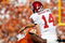 DALLAS - OCTOBER 17:  Quarterback Sam Bradford #14 of the Oklahoma Sooners is tackled by Lamarr Houston #33 of the Texas Longhorns at Cotton Bowl on October 17, 2009 in Dallas, Texas.  (Photo by Ronald Martinez/Getty Images)