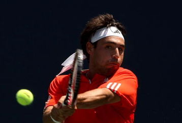LOS ANGELES, CA - JULY 29:  Marcos Baghdatis of Cyprus returns a shot to John Isner during the LA Tennis Open Day Three at Los Angeles Tennis Center - UCLA on July 29, 2009 in Los Angeles, California.  (Photo by Stephen Dunn/Getty Images)