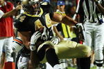 MIAMI - OCTOBER 25:  Fullback Heath Evans #44 of the New Orleans Saints is brought down short of the goal-line by defensive end Phillip Merling #97 of the Miami Dolphins at Land Shark Stadium on October 25, 2009 in Miami, Florida. The Saints defeated the Dolphins 46-34.  (Photo by Doug Benc/Getty Images)