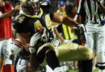 MIAMI - OCTOBER 25:  Fullback Heath Evans #44 of the New Orleans Saints is brought down short of the goal-line by defensive end Phillip Merling #97 of the Miami Dolphins at Land Shark Stadium on October 25, 2009 in Miami, Florida. The Saints defeated the Dolphins 46-34.  (Photo by Doug Benc/Getty Images)