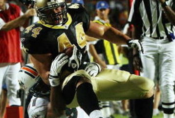 MIAMI - OCTOBER 25:  Fullback Heath Evans #44 of the New Orleans Saints is brought down short of the goal-line by defensive end Phillip Merling #97 of the Miami Dolphins at Land Shark Stadium on October 25, 2009 in Miami, Florida. The Saints defeated the Dolphins 46-34.  (Photo by Doug Benc/Getty Images)