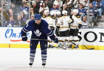 TORONTO - MARCH 28:  Jason Blake #55 of the Toronto Maple Leafs hangs his head as members of the Boston Bruins celebrate a 2nd period goal during their NHL game at the Air Canada Centre March 28, 2009 in Toronto, Ontario.(Photo By Dave Sandford/Getty Images)