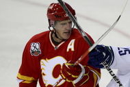 CALGARY, AB - OCTOBER 1: Dion Phaneuf #3 of the Calgary Flames crosses sticks with Sergei Shirokov #25 of the Vancouver Canucks in the second period of NHL action during the season opener on October 1, 2009 at the Pengrowth Saddledome in Calgary, Alberta, Canada. (Photo by Mike Ridewood/Getty Images)