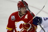 CALGARY, AB - OCTOBER 1: Dion Phaneuf #3 of the Calgary Flames crosses sticks with Sergei Shirokov #25 of the Vancouver Canucks in the second period of NHL action during the season opener on October 1, 2009 at the Pengrowth Saddledome in Calgary, Alberta, Canada. (Photo by Mike Ridewood/Getty Images)