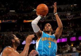 DENVER - APRIL 29:  Chris Paul #3 of the New Orleans Hornets takes a shot Nene #31 of the Denver Nuggets defends in Game Five of the Western Conference Quarterfinals during the 2009 NBA Playoffs at Pepsi Center on April 29, 2009 in Denver, Colorado. The Nuggets defeated the Hornets 107-86. NOTE TO USER: User expressly acknowledges and agrees that, by downloading and or using this photograph, User is consenting to the terms and conditions of the Getty Images License Agreement.  (Photo by Doug Pensinger/Getty Images)