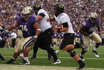 SEATTLE - OCTOBER 24:  Quarterback Jeremiah Masoli #8 of the Oregon Ducks rushes for a touchdown in the first half against Alameda Ta' amu #74 of the Washington Huskies on October 24, 2009 at Husky Stadium in Seattle, Washington. (Photo by Otto Greule Jr/Getty Images)