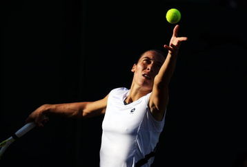 WIMBLEDON, ENGLAND - JUNE 26:  Francesca Schiavone of Italy serves during the women's singles third round match against Marion Bartoli of France on Day Five of the Wimbledon Lawn Tennis Championships at the All England Lawn Tennis and Croquet Club on June 26, 2009 in London, England.  (Photo by Julian Finney/Getty Images)