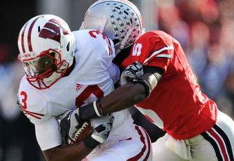 COLUMBUS, OH - OCTOBER 10:  Wide receiver Kyle Jefferson #3 of the Wisconsin Badgers is tackled by Chimdi Chekwa #5 of the Ohio State Buckeyes at Ohio Stadium on October 10, 2009 in Columbus, Ohio.  (Photo by Jamie Sabau/Getty Images)