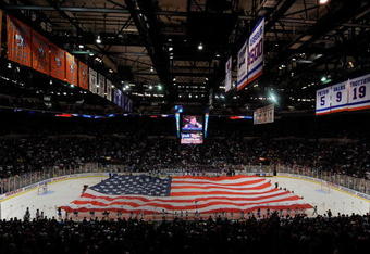 UNIONDALE, NY - OCTOBER 03:  A large American Flag is carried on the ice for the National Anthem during festivities before the home opener NHL hockey game betwen the New York Islanders and the Pittsburgh Penguins on October 3, 2009 at the Nassau Coliseum in Uniondale, New York. The Penguins defeated the Islanders 4-3 in shootout overtime.  (Photo by Paul Bereswill/Getty Images)