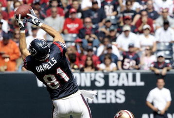 HOUSTON - OCTOBER 25:  Tight-end Owen Daniels #81 of the Houston Texans completes a pass in front of safety Mark Roman #26 of the San Francisco 49ers at Reliant Stadium on October 25, 2009 in Houston, Texas.  (Photo by Bob Levey/Getty Images)