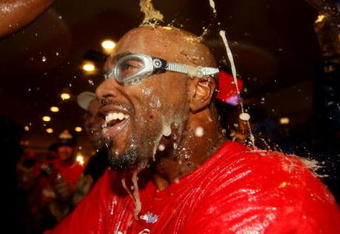 PHILADELPHIA - OCTOBER 21:  Jimmy Rollins #11 of the Philadelphia Phillies is sprayed down with champagne as they celebrate defeating the Los Angeles Dodgers 10-4 to advance to the World Series in Game Five of the NLCS during the 2009 MLB Playoffs at Citizens Bank Park on October 21, 2009 in Philadelphia, Pennsylvania.  (Photo by Nick Laham/Getty Images)
