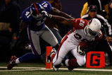 EAST RUTHERFORD, NJ - OCTOBER 25:  Beanie Wells #26 of the Arizona Cardinals stiff arms C.C. Brown #41 of the New York Giants as he runs in for a touchdown on October 25, 2009 at Giants Stadium in East Rutherford, New Jersey.  (Photo by Jared Wickerham/Getty Images)