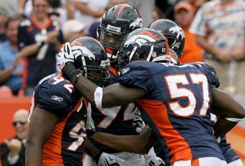 DENVER - SEPTEMBER 20:  Defensive end Elvis Dumervil #92 (L) of the Denver Broncos is congratulated by his teammates after he sacked quarterback Brady Quinn #10 of the Cleveland Browns in the fourth quarter during NFL action at Invesco Field at Mile High on September 20, 2009 in Denver, Colorado. The Broncos defeated the Browns 27-6.  (Photo by Doug Pensinger/Getty Images)