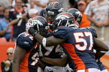 DENVER - SEPTEMBER 20:  Defensive end Elvis Dumervil #92 (L) of the Denver Broncos is congratulated by his teammates after he sacked quarterback Brady Quinn #10 of the Cleveland Browns in the fourth quarter during NFL action at Invesco Field at Mile High on September 20, 2009 in Denver, Colorado. The Broncos defeated the Browns 27-6.  (Photo by Doug Pensinger/Getty Images)