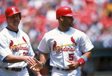 ST. LOUIS - JUNE 17:  Albert Pujols #5 of the St. Louis Cardinals is congratulated by teammate Mark McGwire #25 during the game against the Chicago White Sox at Busch Stadium on June 17, 2001 in St. Louis, Missouri. The Cardinals defeated the White Sox 8-3. (Photo by: Elsa/Getty Images)