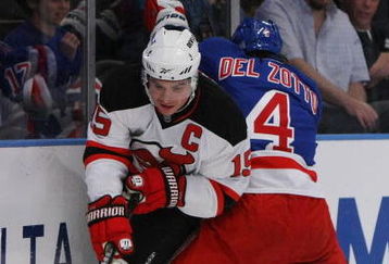 NEW YORK, NY - OCTOBER 22:  Jamie Langenbrunner #15 of the New Jersey Devils handles the puck as Michael Del Zotto #4 of the New York Rangers defends during their game on October 22, 2009 at Madison Square Garden in New York City, New York.  (Photo by Al Bello/Getty Images)