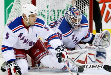 MONTREAL- OCTOBER 24: Daniel Girardi #5 gets down to lcear the puck from in front of Henrik Lundqvist #30 of the New York Rangers during the NHL game against the Montreal Canadiens on October 24, 2009 at the Bell Centre in Montreal, Quebec, Canada. (Photo by Richard Wolowicz/Getty Images)