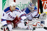 MONTREAL- OCTOBER 24: Daniel Girardi #5 gets down to lcear the puck from in front of Henrik Lundqvist #30 of the New York Rangers during the NHL game against the Montreal Canadiens on October 24, 2009 at the Bell Centre in Montreal, Quebec, Canada. (Photo by Richard Wolowicz/Getty Images)