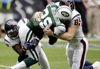 HOUSTON - SEPTEMBER 13: Leon Washington #29 of the New York Jets is tackled by Joel Dreesen #85 of the Houston Texans and Antwaun Molden #28 on a punt return at Reliant Stadium on September 13, 2009 in Houston, Texas.  (Photo by Bob Levey/Getty Images)
