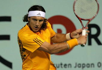 TOKYO - OCTOBER 08:  Juan Monaco of Argentina returns a shot in his match against Ernests Gulbis of Latvia during day four of the Rakuten Open Tennis tournament at Ariake Colosseum on October 8, 2009 in Tokyo, Japan.  (Photo by Kiyoshi Ota/Getty Images)