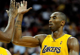 LAS VEGAS - OCTOBER 15:  Kobe Bryant #24 of the Los Angeles Lakers high-fives  Andrew Bynum #17 during their preseason game against the Sacramento Kings at the Thomas & Mack Center October 15, 2009 in Las Vegas, Nevada. NOTE TO USER: User expressly acknowledges and agrees that, by downloading and/or using this Photograph, user is consenting to the terms and conditions of the Getty Images License Agreement.  (Photo by Ethan Miller/Getty Images)