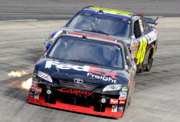 MARTINSVILLE, VA - OCTOBER 25:  Denny Hamlin, driver of the #11 FedEx Freight Toyota, leads Jimmie Johnson, driver of the #48 Lowe's Chevrolet, during the NASCAR Sprint Cup Series TUMS Fast Relief 500 at Martinsville Speedway on October 25, 2009 in Martinsville, Virginia.  (Photo by John Harrelson/Getty Images)