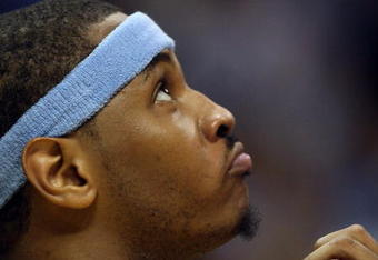 DENVER - MAY 29:  Carmelo Anthony #15 of the Denver Nuggets looks on from the bench in the fourth quarter of Game Six of the Western Conference Finals during the 2009 NBA Playoffs against the Los Angeles Lakers at Pepsi Center on May 29, 2009 in Denver, Colorado. NOTE TO USER: User expressly acknowledges and agrees that, by downloading and or using this photograph, User is consenting to the terms and conditions of the Getty Images License Agreement.  (Photo by Jed Jacobsohn/Getty Images)