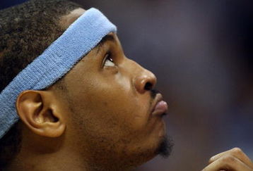 DENVER - MAY 29:  Carmelo Anthony #15 of the Denver Nuggets looks on from the bench in the fourth quarter of Game Six of the Western Conference Finals during the 2009 NBA Playoffs against the Los Angeles Lakers at Pepsi Center on May 29, 2009 in Denver, Colorado. NOTE TO USER: User expressly acknowledges and agrees that, by downloading and or using this photograph, User is consenting to the terms and conditions of the Getty Images License Agreement.  (Photo by Jed Jacobsohn/Getty Images)