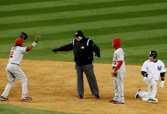 NEW YORK - OCTOBER 17:  Erick Aybar #2 of the Los Angeles Angels of Anaheim reacts to a call by second base umpire Jerry Layne that Melky Cabrera #53 of the New York Yankees was safe at second base in the bottom of the tenth inning of Game Two of the ALCS during the 2009 MLB Playoffs at Yankee Stadium on October 17, 2009 in the Bronx borough of New York City.  (Photo by Jim McIsaac/Getty Images)