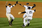NEW YORK - OCTOBER 25:  Alex Rodriguez #13, Derek Jeter #2 and Mark Teixeira #25 of the New York Yankees celebrate their 5-2 victory over the Los Angeles Angels of Anaheim at the end of the top of the ninth inning in Game Six of the ALCS during the 2009 MLB Playoffs at Yankee Stadium on October 25, 2009 in the Bronx borough of New York City. The New York Yankees won the ALCS series 4-2 over the Los Angeles Angels of Anaheim to capture the American League pennant.  (Photo by Jim McIsaac/Getty Images)