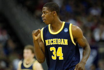 KANSAS CITY, MO - MARCH 21:   DeShawn Sims #34 of the Michigan Wolverines pumps his fist after a scoring play in the first half against the Oklahoma Sooners during the second round of the NCAA Division I Men's Basketball Tournament at the Sprint Center on March 21, 2009 in Kansas City, Missouri.  (Photo by Jamie Squire/Getty Images)