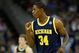 KANSAS CITY, MO - MARCH 21:   DeShawn Sims #34 of the Michigan Wolverines pumps his fist after a scoring play in the first half against the Oklahoma Sooners during the second round of the NCAA Division I Men's Basketball Tournament at the Sprint Center on March 21, 2009 in Kansas City, Missouri.  (Photo by Jamie Squire/Getty Images)