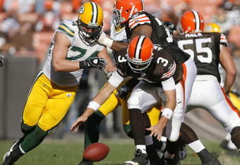 CLEVELAND, OH - OCTOBER 25:  Derek Anderson #3 of the Cleveland Browns fights for a fumble with Aaron Kampman #74 the Green Bay Packers at Cleveland Browns at Cleveland Browns Stadium on October 25, 2009 in Cleveland, Ohio.  (Photo by Matt Sullivan/Getty Images)